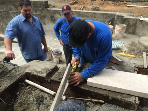 Pool builders work in Victoria Deal's Folsom back yard.